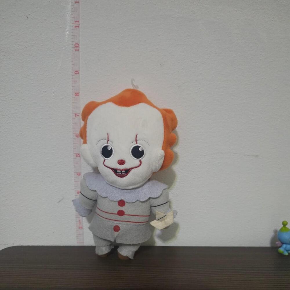 Pennywise plush doll with orange hair, white face, red lips, and red buttons #cl